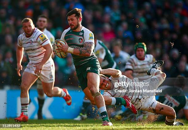 Adam Thompstone of Leicester avoids a tackle from Andrew Fenby of London Irish during the Aviva Premiership match between Leicester Tigers and London...