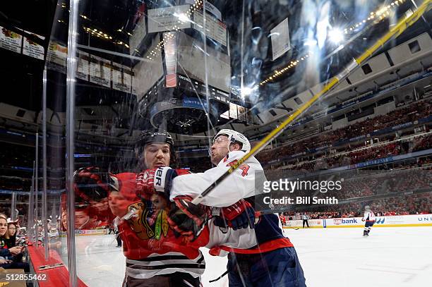 Andrew Shaw of the Chicago Blackhawks and Brooks Orpik of the Washington Capitals get physical in the first period of the NHL game at the United...