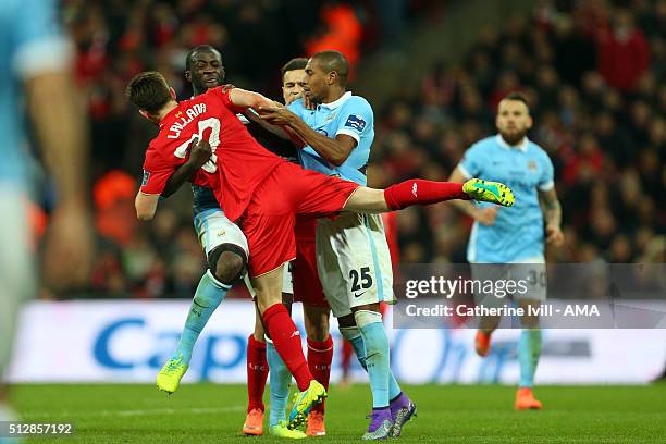 Yaya Toure of Manchester City picks up Adam Lallana of Liverpool as things get heated during the Capital One Cup Final match between Liverpool and...