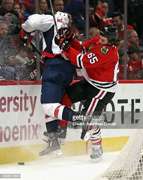 Andrew Shaw of the Chicago Blackhawks check Matt Niskanen of the Washington Capitals into the boards at the United Center on February 28, 2016 in...