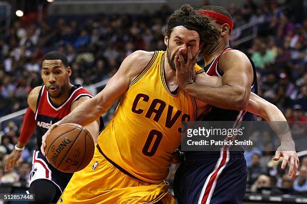 Kevin Love of the Cleveland Cavaliers is fouled by Jared Dudley of the Washington Wizards during the first half at Verizon Center on February 28,...