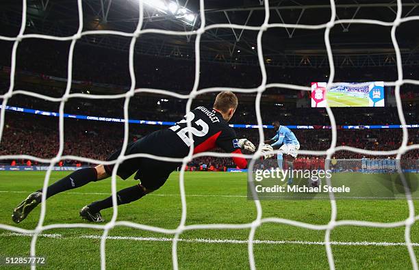 Yaya Toure of Manchester City scores the winning penalty past goalkeeper Simon Mignolet of Liverpool to win the shoot out during the Capital One Cup...