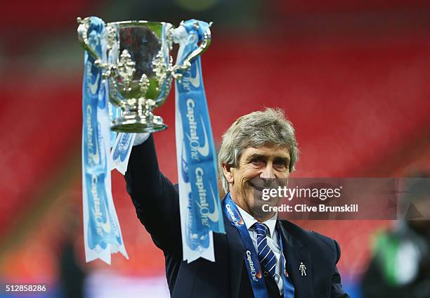 Manuel Pellegrini manager of Manchester City celebrates victory with the trophy after the Capital One Cup Final match between Liverpool and...