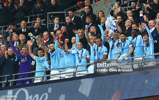 Captain Vincent Kompany of Manchester City lifts the trophy with team mates in celebration after the Capital One Cup Final match between Liverpool...