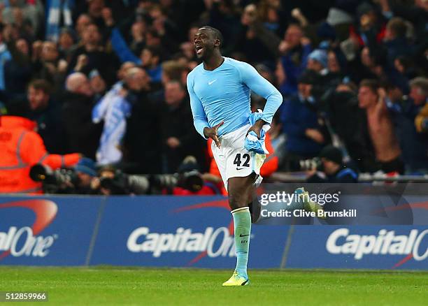 Yaya Toure of Manchester City celebrates as he scores the winning penalty to win the shoot out during the Capital One Cup Final match between...