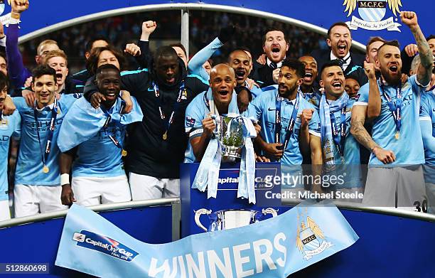 Vincent Kompany of Manchester City and team mates celebrate victory with the trophy after the Capital One Cup Final match between Liverpool and...