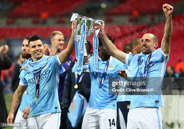 Sergio Aguero of Manchester City and team mate Pablo Zabaleta celebrate victory with the trophy after the Capital One Cup Final match between...
