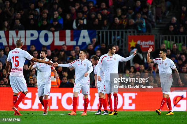 Victor Machin 'Vitolo' of Sevilla FC celebrates with his team mates after scoring the opening goal past Claudio Bravo of FC Barcelona during the La...
