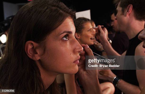 Model gets made-up backstage at the Matthew Williamson Spring 2005 collection show during the Olympus Fashion Week in Splash Light Studios September...