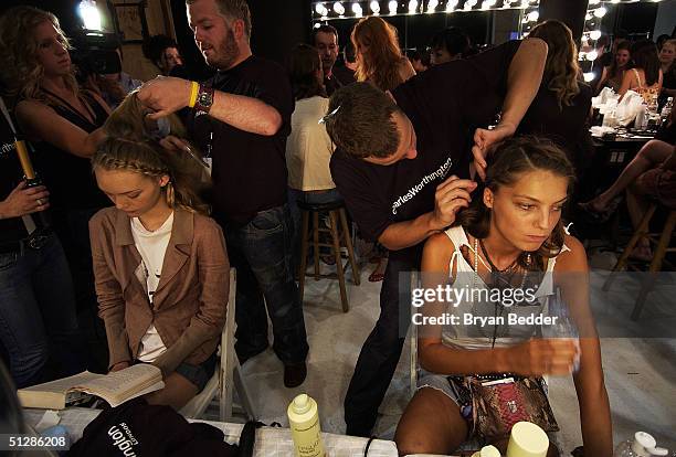 Models get their hair done backstage at the Matthew Williamson Spring 2005 collection show during the Olympus Fashion Week in Splash Light Studios...