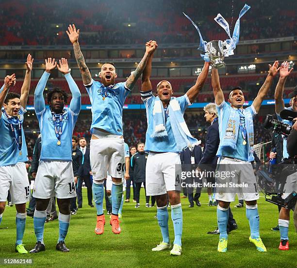 Vincent Kompany of Manchester City and team mates Jesus Navas , Wilfred Bony , Nicolas Otamendi and Sergio Aguero celebrate victory with the trophy...