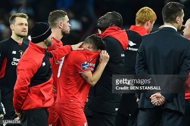 Liverpool's Brazilian midfielder Philippe Coutinho reacts after his penalty gets saved during the penalty shoot-out in the English League Cup final...