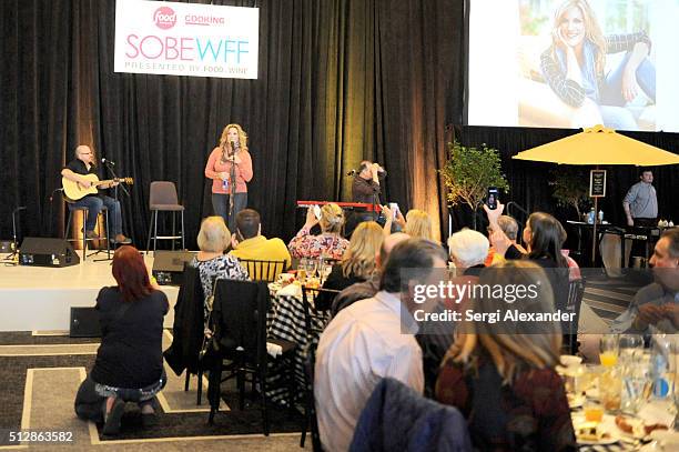 Guests enjoying Trisha Yearwood sing during the Southern Kitchen Brunch Hosted By Trisha Yearwood - Part of The NYT Cooking Series during 2016 Food...
