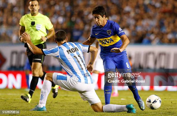 Pablo Perez of Boca Juniors fights for the ball with Luciano Aued of Racing Club during a fifth round match between Racing Club and Boca Juniors as...