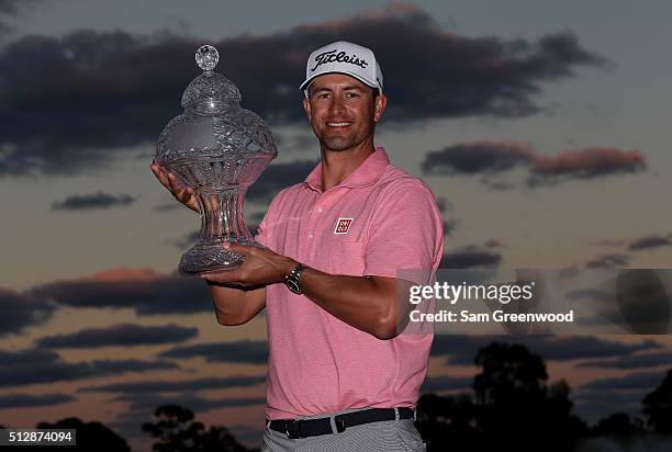 Adam Scott of Australia poses with the trophy after his one shot victory over Sergio Garcia following the final round of The Honda Classic at PGA...
