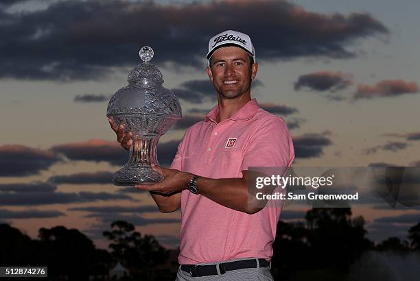 Adam Scott of Australia poses with the trophy after his one shot victory over Sergio Garcia following the final round of The Honda Classic at PGA...