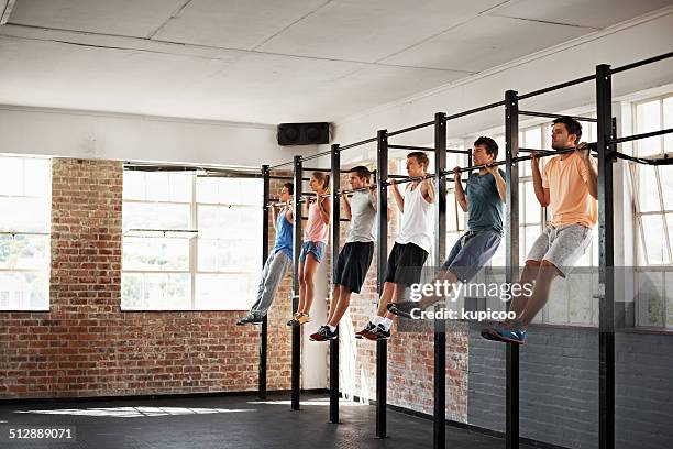 working the upper body - chin ups stockfoto's en -beelden