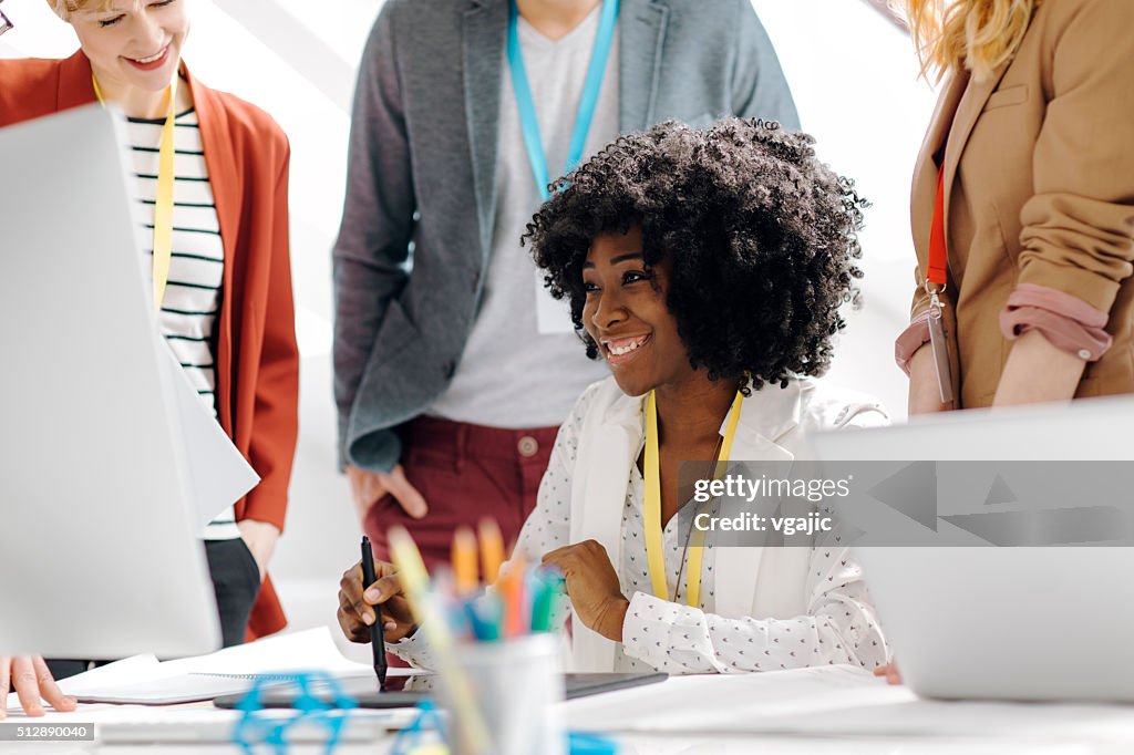 Team Leader Surrounded with her coworkers.