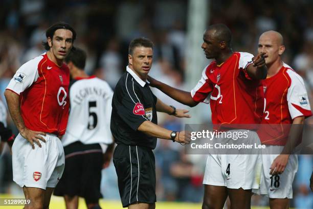 Arsenal players Robert Pires, Patrick Vieira, and Pascal Cygan argue with referee Mark Halsey over a penalty decision during the Barclays Premiership...