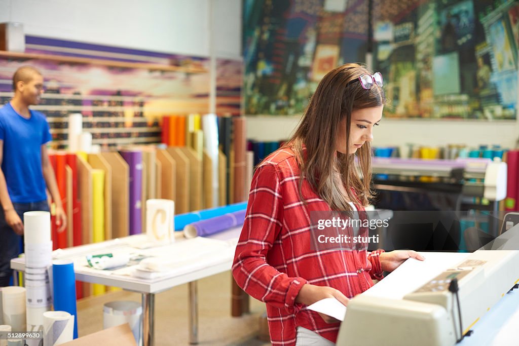 Woman working at a digital printers