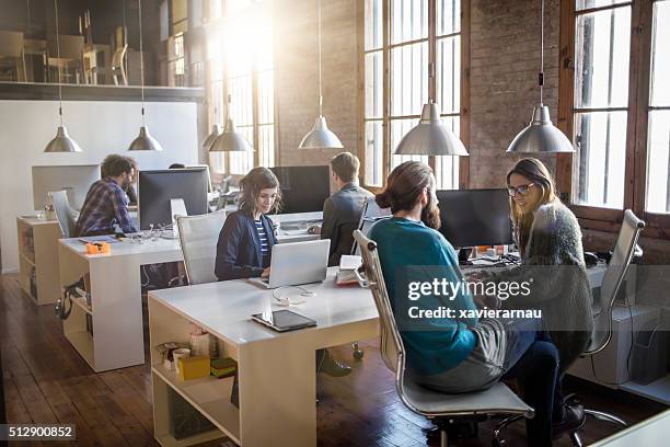 young creative business people working in the office - small office stock pictures, royalty-free photos & images