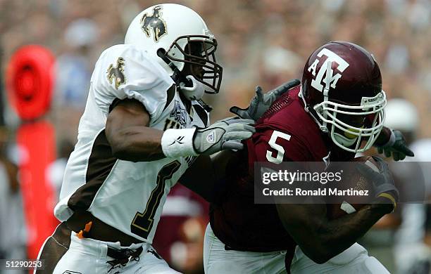 Wide receiver Terrence Murphy of the Texas A&M University Aggies makes a 48 yard pass reception against Derrick Martin of the University of Wyoming...