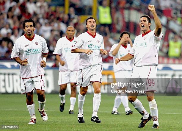Alessandro Lucarelli of Livorno celebrates a goal with team-mates during the Serie A match between AC Milan and Livorno at the San Siro stadium on...