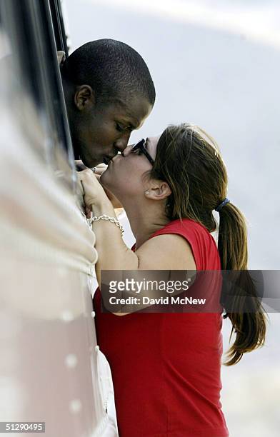 Lance Corporal Derrick Rogers and Natalie Munoz kiss through a bus window on September 11, 2004 at Camp Pendleton, California before the Third...