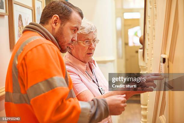 heating system for senior woman - security equipment stock pictures, royalty-free photos & images