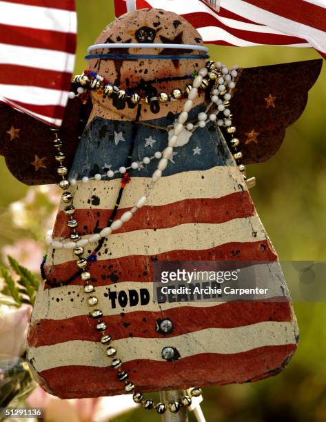Wooden angel hangs in remembrance of Todd Beamer September 11, 2004 near Shankville, Pennsylvania. It is one of forty small monuments to those who...