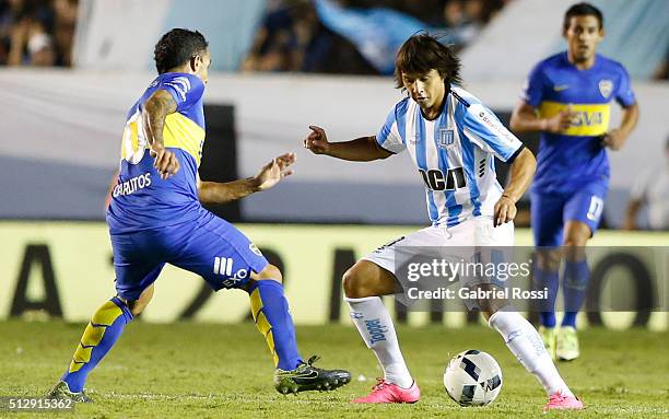 Oscar Romero of Racing Club fights for the ball with Carlos Tevez of Boca Juniors during a fifth round match between Racing Club and Boca Juniors as...