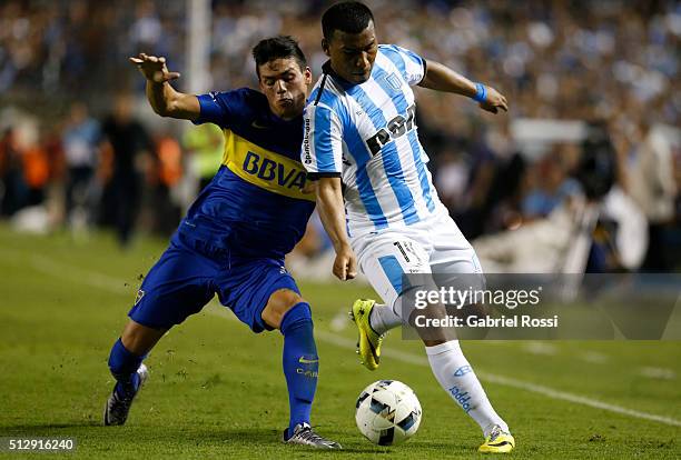 Roger Martinez of Racing Club fights for the ball with Jonathan Silva of Boca Juniors during a fifth round match between Racing Club and Boca Juniors...