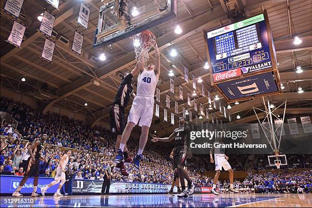 Marshall Plumlee of the Duke Blue Devils dunks over Boris Bojanovsky of the Florida State Seminoles during their game at Cameron Indoor Stadium on...