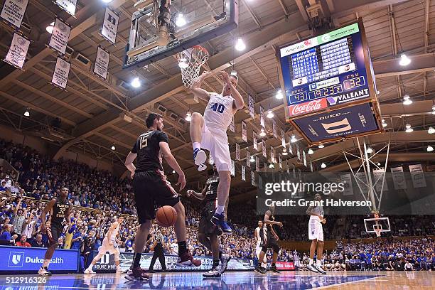 Marshall Plumlee of the Duke Blue Devils dunks over Boris Bojanovsky of the Florida State Seminoles during their game at Cameron Indoor Stadium on...
