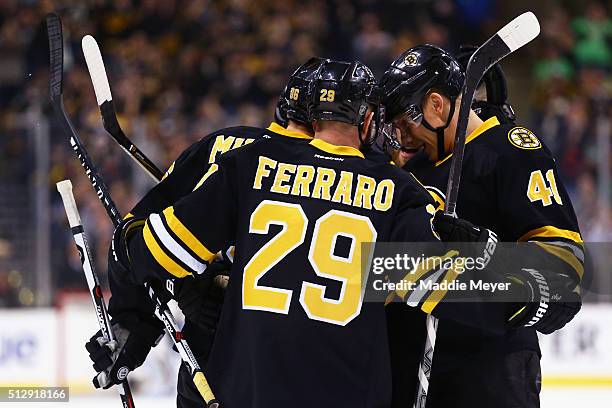 Kevan Miller of the Boston Bruins celebrates with Landon Ferraro and Joonas Kemppainen after scoring against the Tampa Bay Lightning during the first...