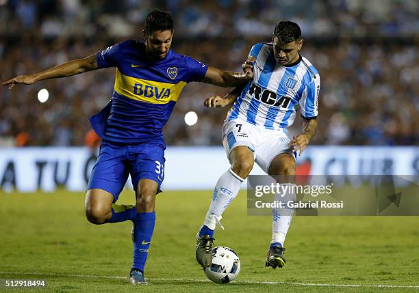 Gustavo Bou of Racing Club fights for the ball with Juan Manuel Insaurralde of Boca Juniors during a fifth round match between Racing Club and Boca...