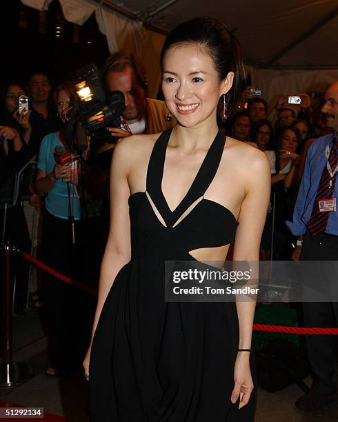 Actor Zhang Ziyi poses for the cameras on the red carpet at the North American premiere of "House of Flying Daggers" during the 29th Annual Toronto...