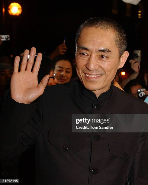 Director Zhang Yimou waves for the cameras on the red carpet at the North American premiere of "House of Flying Daggers" during the 29th Annual...