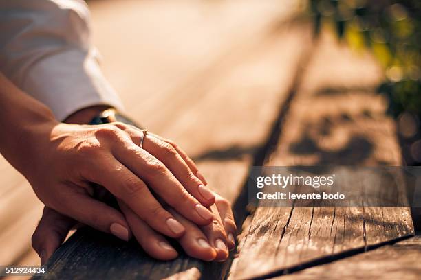 holding hands with wedding rings, wedding and engagement background - outdoor wedding ceremony vows stock pictures, royalty-free photos & images