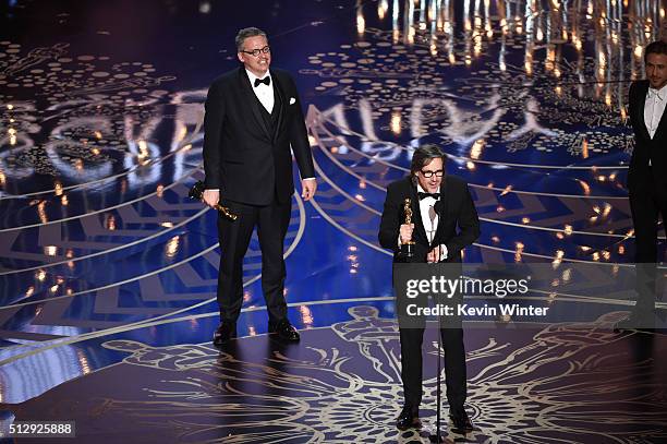 Screenwriter-director Adam McKay and screenwriter Charles Randolph accept the Best Adapted Screenplay award for 'The Big Short' onstage during the...