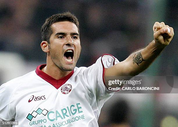 Livorno's forward Cristiano Lucarelli celebrates after scoring against AC Milan during their Serie A football match at San Siro Stadium in Milan, 11...