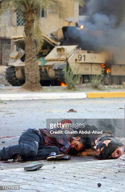 Dead and critically injured Iraqi civilians are seen lying in the street on September 12, 2004 in Haifa Street, Baghdad, Iraq. Fighting broke out in...
