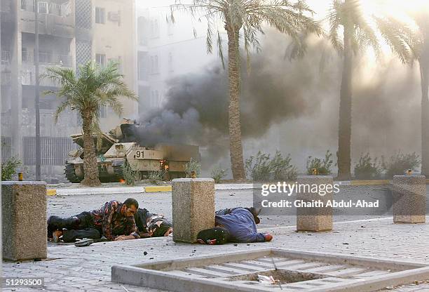 Dead and critically injured Iraqi civilians are seen lying in the street on September 12, 2004 in Haifa Street, Baghdad, Iraq. Fighting broke out in...