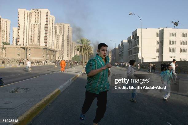 Iraqi civilians runaway after U.S. Helicopters opened fire on September 12, 2004 in Haifa Street, Baghdad, Iraq. Fighting broke out in the early...