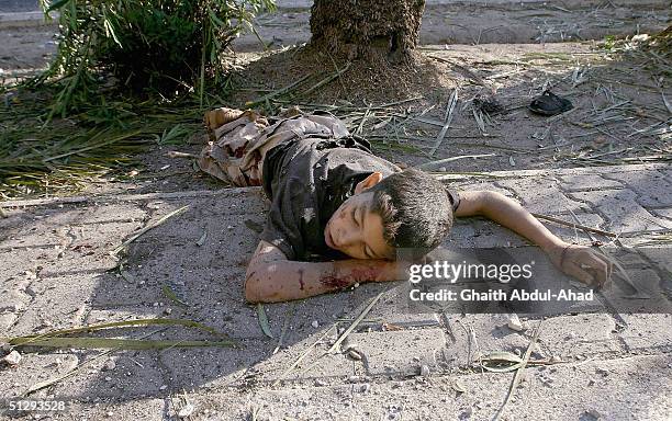 Dead Iraqi boy is seen lying in the street on September 12, 2004 in Haifa Street, Baghdad, Iraq. Fighting broke out in the early hours of September...