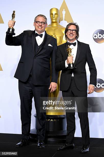 Writers Adam McKay and Charles Randolph, winners of the Best Writing award for 'The Big Short,' pose in the press room during the 88th Annual Academy...