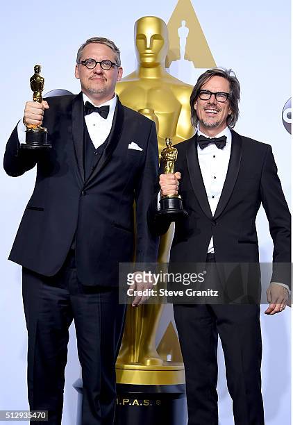 Writers Adam McKay and Charles Randolph, winners of the Best Writing award for 'The Big Short,' pose in the press room during the 88th Annual Academy...