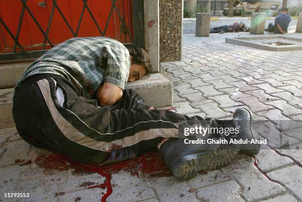Critically Injured Iraqi civilian takes cover as his life ebbs away on September 12, 2004 in Haifa Street, Baghdad, Iraq. Fighting broke out in the...