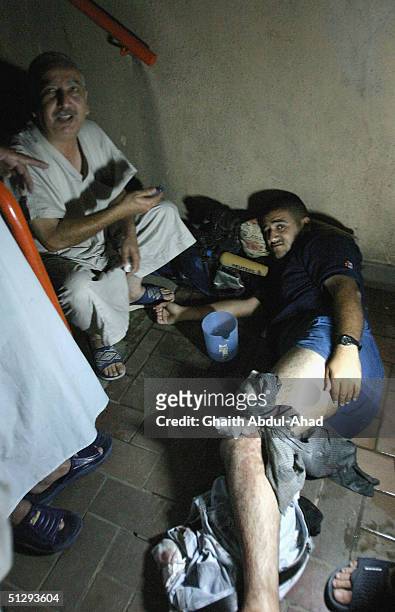 Reuters camera man lies injured in the basement of a building in Haifa Street on September 12, 2004 in Baghdad, Iraq. Fighting broke out in the early...