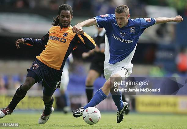 Ian Westlake of Ipswich holds off Adrian Serioux of Millwall during the Coca Cola Championship match between Ipswich Town v Millwall at Portman Road...